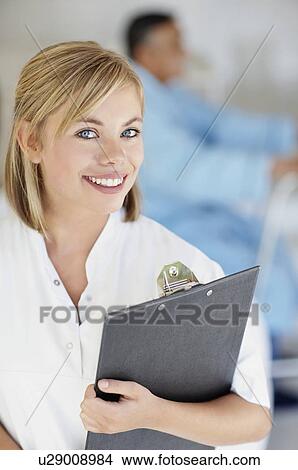 Nurse holding a clipboard View Large Photo Image Picture - Nurse holding a clipboard. Fotosearch