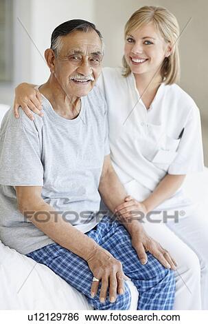 Nurse sitting with patient View Large Photo Image Stock Photograph - Nurse sitting with patient. Fotosearch