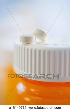 Pills on top of bottle of prescription medication View Large Photo Image Stock Image - Pills on top of bottle of prescription medication. Fotosearch