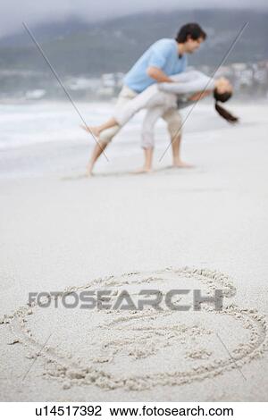 Playful couple at the beach View Large Photo Image Stock Image - Playful couple at the beach. Fotosearch