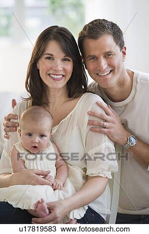 Portrait of parents and their baby daughter View Large Photo Image Stock Image - Portrait of parents and their baby daughter. Fotosearch