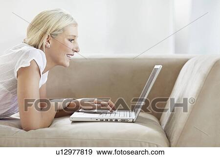 Pretty blond woman browsing the internet View Large Photo Image Stock Photo - Pretty blond woman browsing the internet. Fotosearch