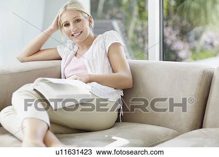 Pretty blond woman reading a book View Large Photo Image Stock Image - Pretty blond woman reading a book. Fotosearch