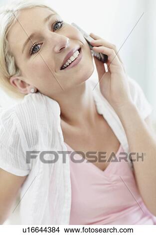 Picture - Pretty blond woman talking on phone. Fotosearch