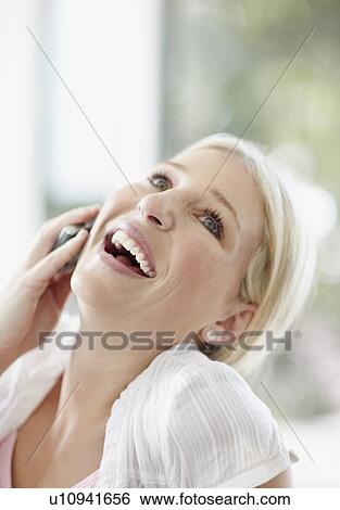 Pretty blond woman talking on phone View Large Photo Image Stock Photograph - Pretty blond woman talking on phone. Fotosearch