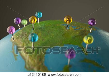 Stock Photograph - Push pins on globe. Fotosearch