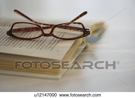 Reading glasses on book View Large Photo Image Stock Image - Reading glasses on book. Fotosearch