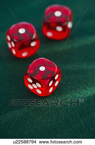 Picture - Red dice on green felt. Fotosearch