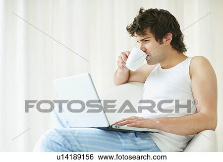 Relaxed man browsing the internet View Large Photo Image Stock Photograph - Relaxed man browsing the internet. Fotosearch