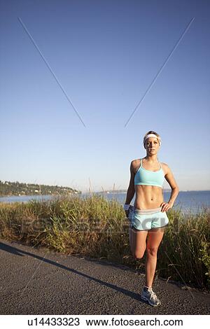 Stock Image - Runner stretching. Fotosearch