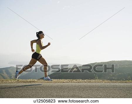 Runner training on the side of the road View Large Photo Image Stock Image - Runner training on the side of the road. Fotosearch