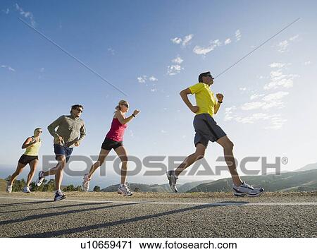 Stock Image - Runners on a road in Malibu. Fotosearch