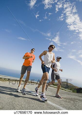 Stock Image - Runners on a road in Malibu. Fotosearch