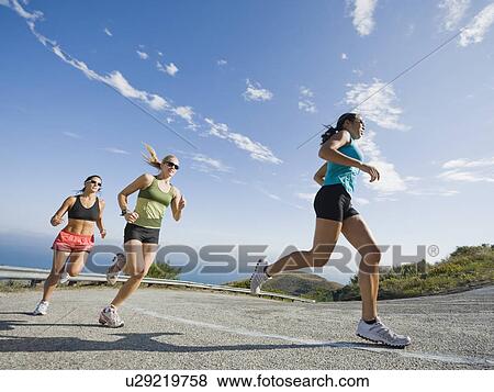 Stock Photo - Runners on a road in Malibu. Fotosearch