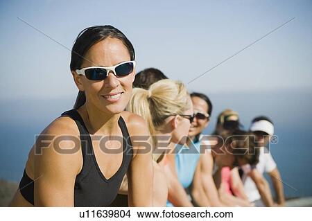 Picture - Runners resting on the side of the road. Fotosearch