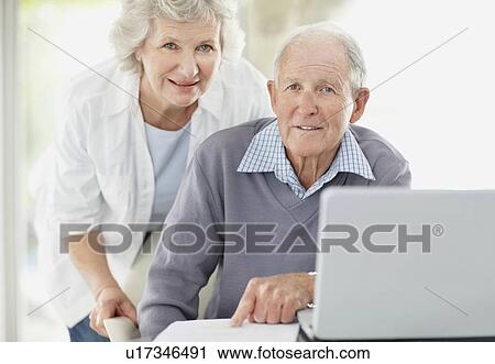 Senior couple doing paperwork together View Large Photo Image Stock Image - Senior couple doing paperwork together. Fotosearch
