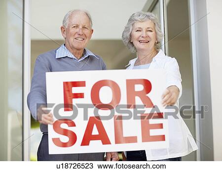 Senior couple holding for sale sign View Large Photo Image Stock Image - Senior couple holding for sale sign. Fotosearch