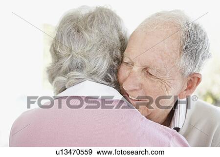 Stock Photo - Senior couple hugging. Fotosearch