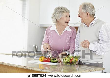 Picture - Senior couple preparing salad together. Fotosearch