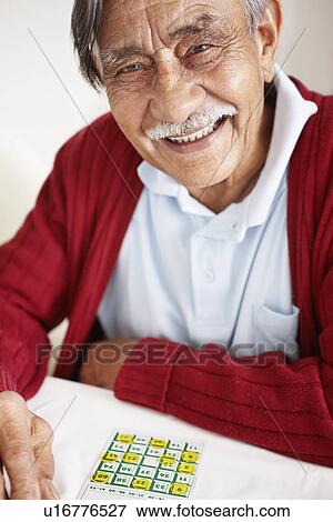 Senior man playing bingo View Large Photo Image Stock Photo - Senior man playing bingo. Fotosearch