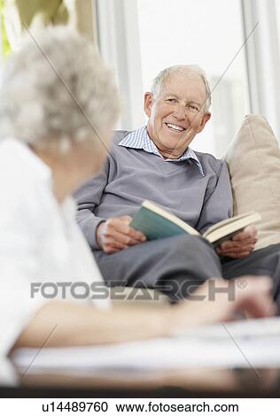 Stock Image - Senior man reading a book. Fotosearch