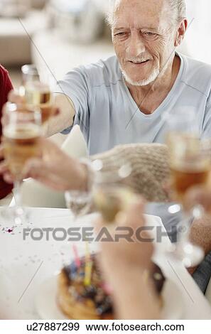 Stock Photo - Senior man toasting with a glass of champagne. Fotosearch