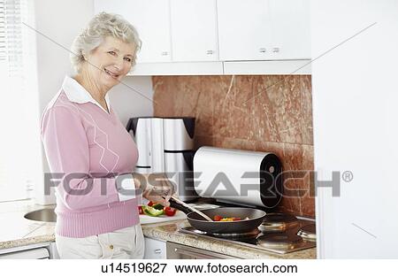 Senior woman cooking View Large Photo Image Stock Photo - Senior woman cooking. Fotosearch