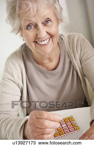 Senior woman playing bingo View Large Photo Image Stock Image - Senior woman playing bingo. Fotosearch