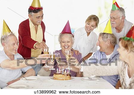 Stock Image - Senior woman's birthday party. Fotosearch