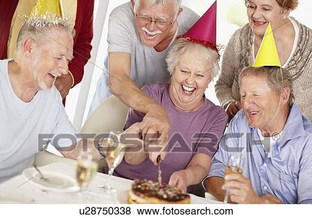 Stock Photo - Senior woman's birthday party. Fotosearch