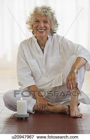 Serene woman sitting on floor View Large Photo Image Stock Photo - Serene woman sitting on floor. Fotosearch