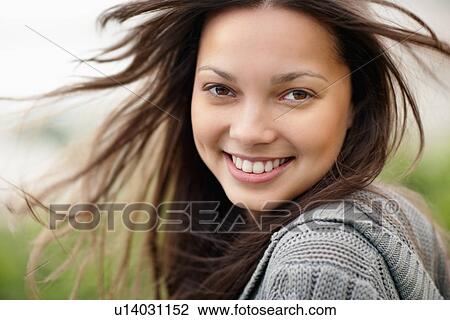 Stock Image - Smiling attractive brunette woman. Fotosearch