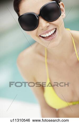 Smiling woman wearing bikini and sunglasses View Large Photo Image Stock Photograph - Smiling woman wearing bikini and sunglasses. Fotosearch