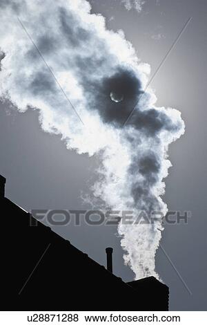 Stock Photo - Smoke coming out of factory chimney. Fotosearch