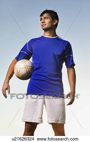 Soccer player holding ball View Large Photo Image Picture - Soccer player holding ball. Fotosearch