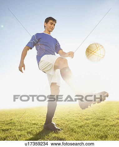 Soccer player kicking the ball View Large Photo Image Picture - Soccer player kicking the ball. Fotosearch