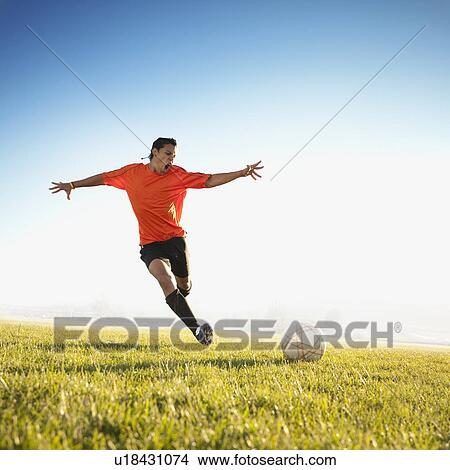 Soccer player kicking the ball View Large Photo Image Picture - Soccer player kicking the ball. Fotosearch