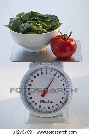 Spinach and tomato on kitchen scale View Large Photo Image Stock Image - Spinach and tomato on kitchen scale. Fotosearch