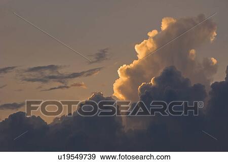 Stock Photo - Sunset behind clouds. Fotosearch