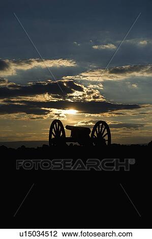 Stock Image - Sunset over civil war cannon. Fotosearch