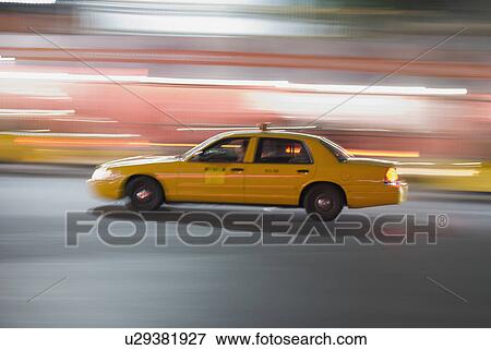 Stock Photo - Taxi cab driving at night. Fotosearch
