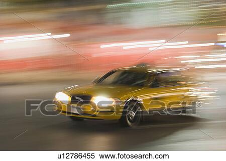 Stock Photography - Taxi cab driving at night. Fotosearch