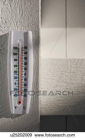 Stock Photo - Thermometer on wall. Fotosearch