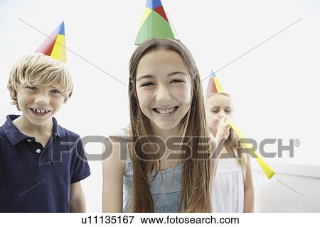 Three children wearing birthday hats View Large Photo Image Stock Photo - Three children wearing birthday hats. Fotosearch