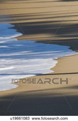 Stock Image - Tide on Caribbean beach. Fotosearch