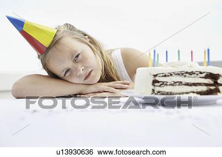 Stock Photograph - Tired birthday girl. Fotosearch