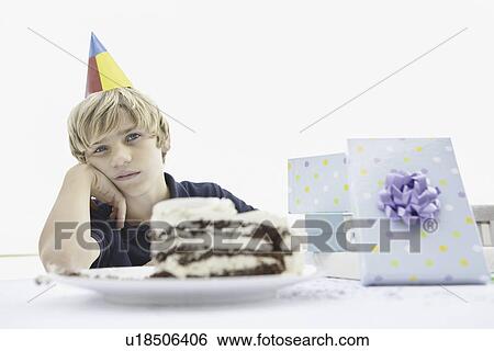 Tired young boy at a birthday party View Large Photo Image Stock Photograph - Tired young boy at a birthday party. Fotosearch
