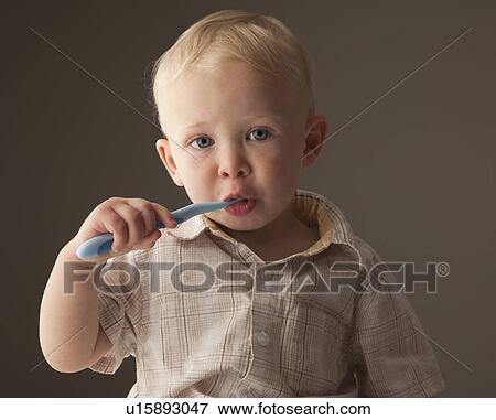 Stock Photo - Toddler brushing his teeth. Fotosearch