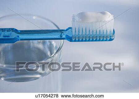 Stock Photo - Toothbrush and glass of water. Fotosearch