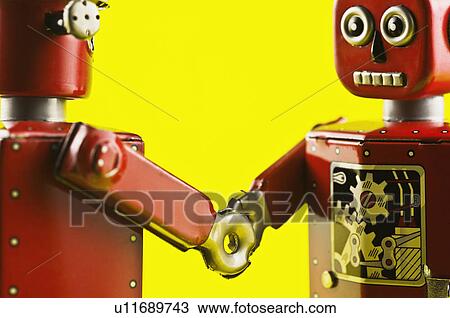 Toy robots shaking hands View Large Photo Image Stock Image - Toy robots shaking hands. Fotosearch